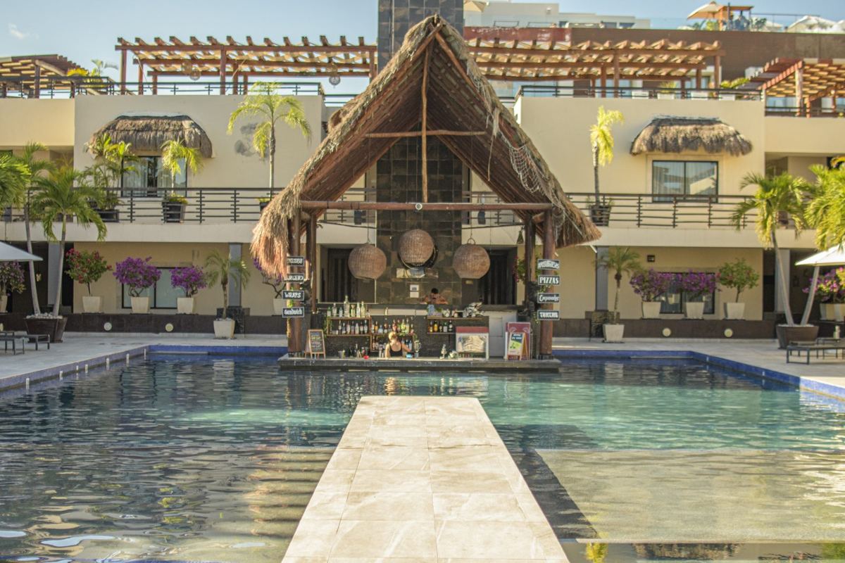 The Village Pool and its swim-up bar under the great palapa