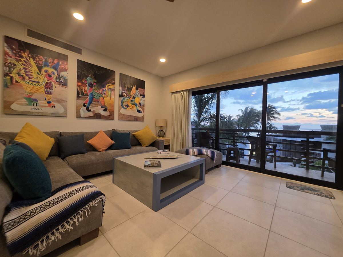 La sala de una residencia de dos recámaras, abierta a la terraza